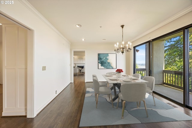 616 NW Westover Ter, Portland, OR 97210 - dining room with ornamental molding, dark wood-style flooring, a chandelier, recessed lighting, and baseboards