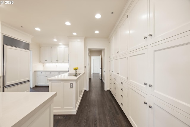 616 NW Westover Ter, Portland, OR 97210 - kitchen featuring paneled refrigerator, white cabinets, recessed lighting, light countertops, and dark wood finished floors