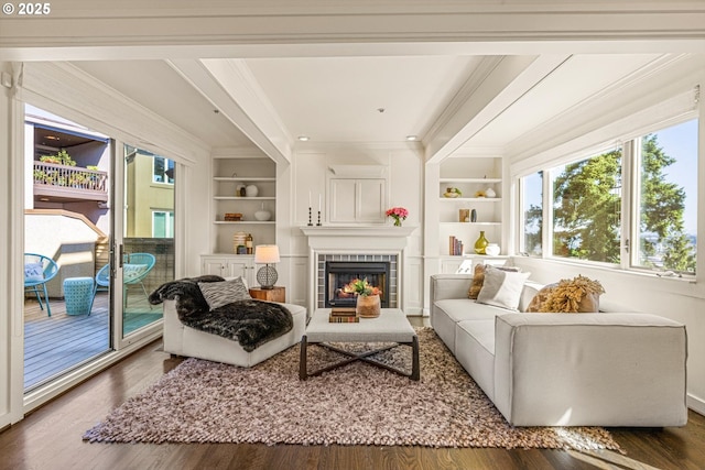 616 NW Westover Ter, Portland, OR 97210 - living room featuring built in features, ornamental molding, a fireplace, and wood finished floors