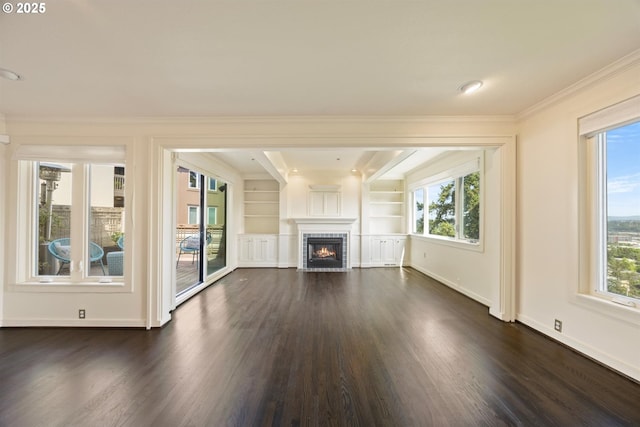 616 NW Westover Ter, Portland, OR 97210 - unfurnished living room with dark wood-style floors, crown molding, baseboards, a fireplace, and built in features