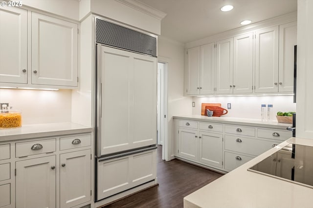 616 NW Westover Ter, Portland, OR 97210 - kitchen with dark wood-style flooring, paneled built in fridge, white cabinets, recessed lighting, and light countertops