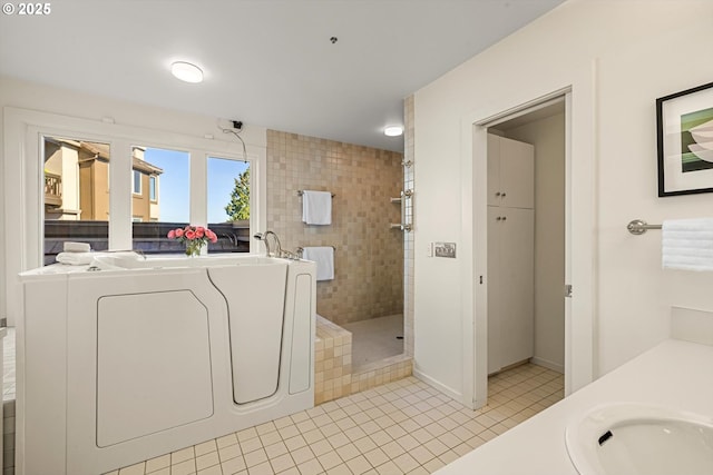 616 NW Westover Ter, Portland, OR 97210 - bathroom with washer / clothes dryer, a walk in shower, tile patterned flooring, and vanity