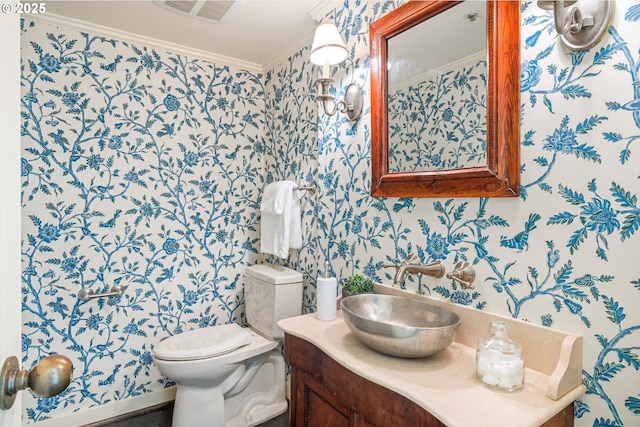 616 NW Westover Ter, Portland, OR 97210 - half bathroom featuring wallpapered walls, crown molding, toilet, and vanity
