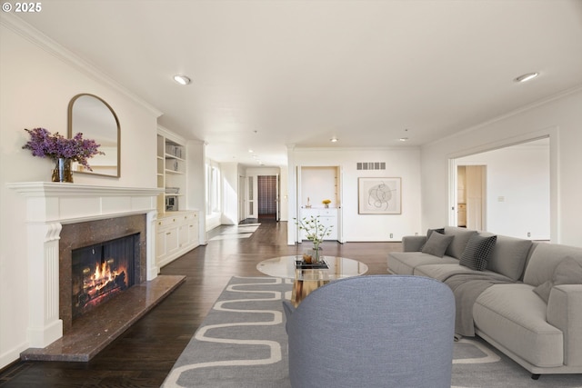 616 NW Westover Ter, Portland, OR 97210 - living area featuring a premium fireplace, crown molding, recessed lighting, dark wood-style floors, and built in features