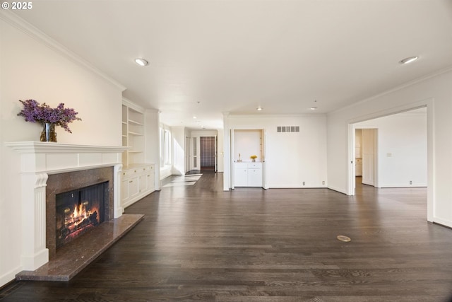 616 NW Westover Ter, Portland, OR 97210 - unfurnished living room featuring dark wood-type flooring, a premium fireplace, crown molding, recessed lighting, and baseboards
