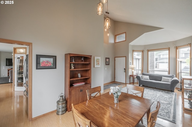 7874 Jani Ct NE, Keizer, OR 97303 - dining area featuring high vaulted ceiling, baseboards, and light wood-style floors