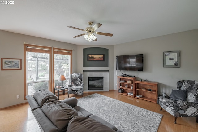 7874 Jani Ct NE, Keizer, OR 97303 - living room featuring ceiling fan, a tile fireplace, light wood finished floors, and baseboards
