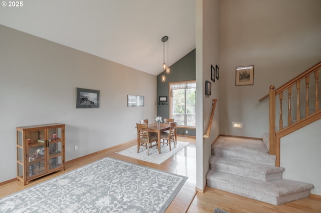 7874 Jani Ct NE, Keizer, OR 97303 - dining area with stairway, wood finished floors, baseboards, and high vaulted ceiling