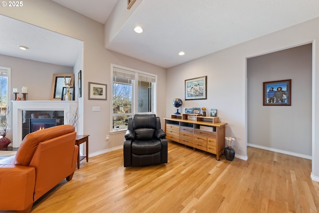 sitting room featuring light wood-type flooring and a fireplace