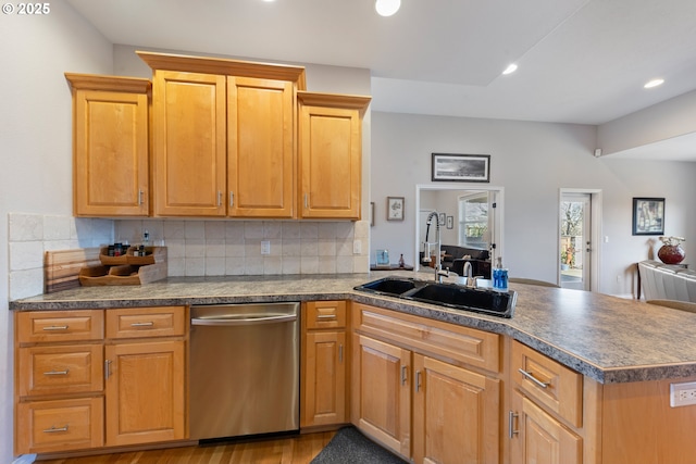 kitchen featuring sink, decorative backsplash, stainless steel dishwasher, kitchen peninsula, and light hardwood / wood-style flooring