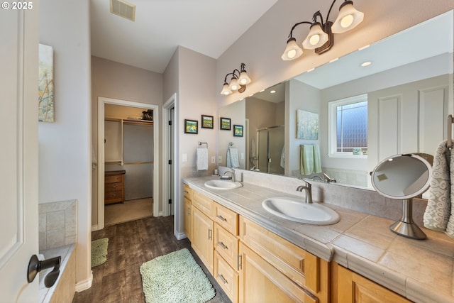 bathroom featuring a shower with door, vanity, and hardwood / wood-style floors