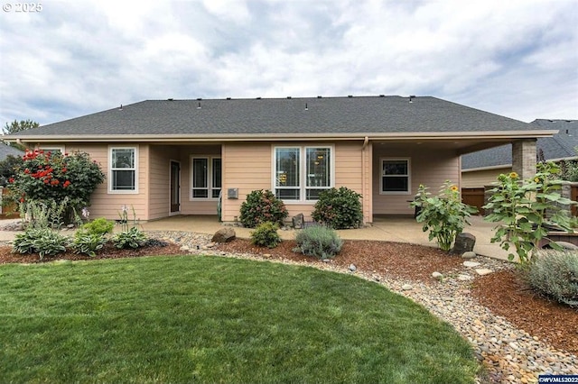 rear view of property with a lawn and a patio area