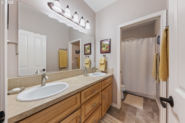 bathroom with tile patterned floors, toilet, and vanity