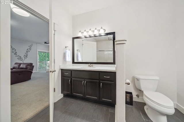 7540 SW Becky Ct, Beaverton, OR 97007 - ensuite bathroom with toilet, vanity, baseboards, and wood tiled floors