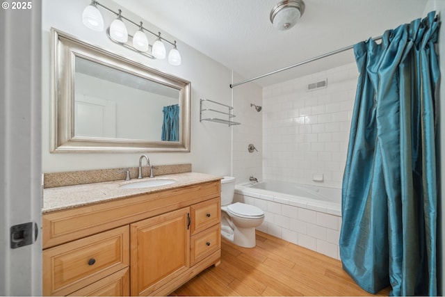 7540 SW Becky Ct, Beaverton, OR 97007 - bathroom with toilet, wood finished floors, tiled shower / bath combo, and vanity