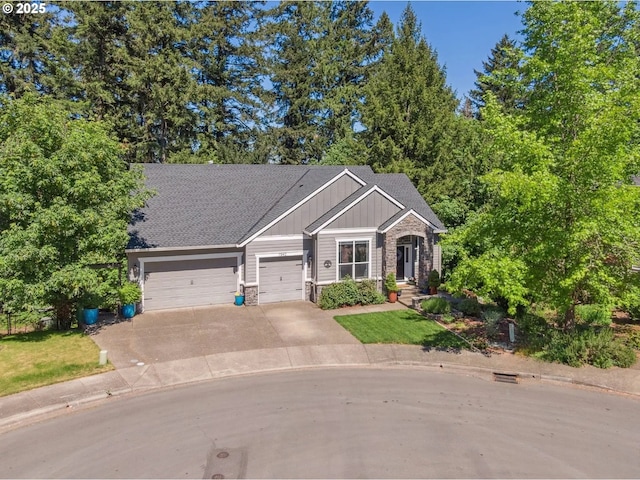 7540 SW Becky Ct, Beaverton, OR 97007 - craftsman-style home with board and batten siding, an attached garage, stone siding, concrete driveway, and a shingled roof