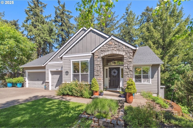 7540 SW Becky Ct, Beaverton, OR 97007 - craftsman-style home featuring stone siding, board and batten siding, driveway, a garage, and a shingled roof