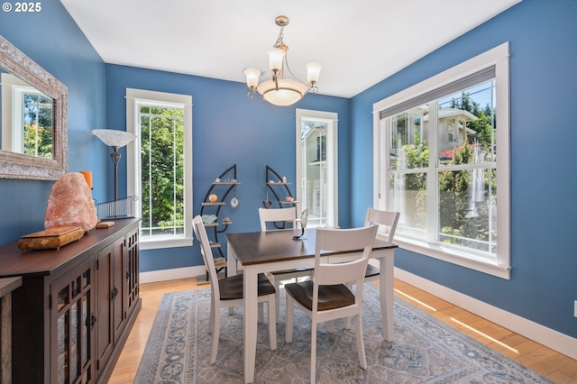 7540 SW Becky Ct, Beaverton, OR 97007 - dining space featuring a chandelier, baseboards, and light wood finished floors