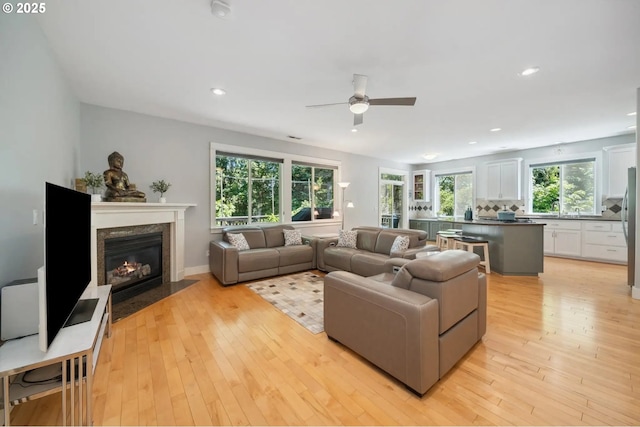 7540 SW Becky Ct, Beaverton, OR 97007 - living room featuring ceiling fan, light wood-style floors, a premium fireplace, and recessed lighting
