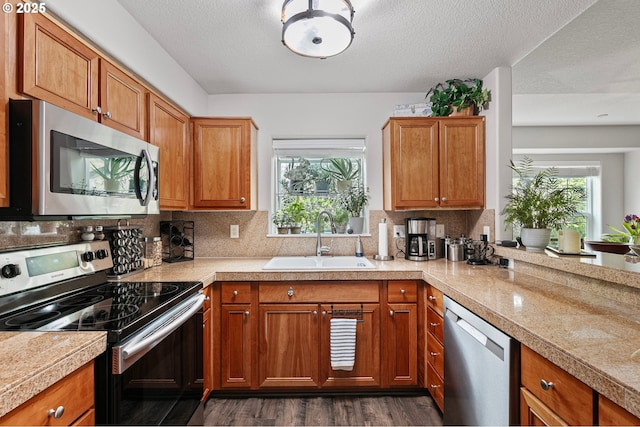 30366 SW Ruth St Unit 70, Wilsonville, OR 97070 - kitchen with plenty of natural light, tile countertops, a sink, dark wood finished floors, and stainless steel appliances