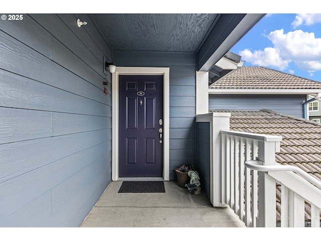 property entrance with a tiled roof