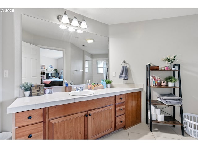 ensuite bathroom with connected bathroom, tile patterned flooring, and vanity