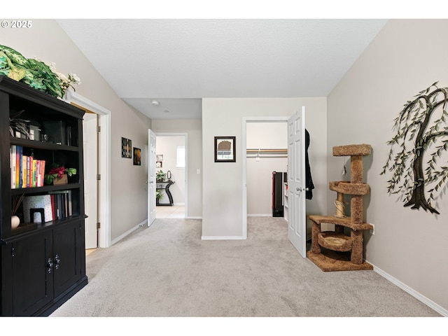 corridor with carpet floors and baseboards
