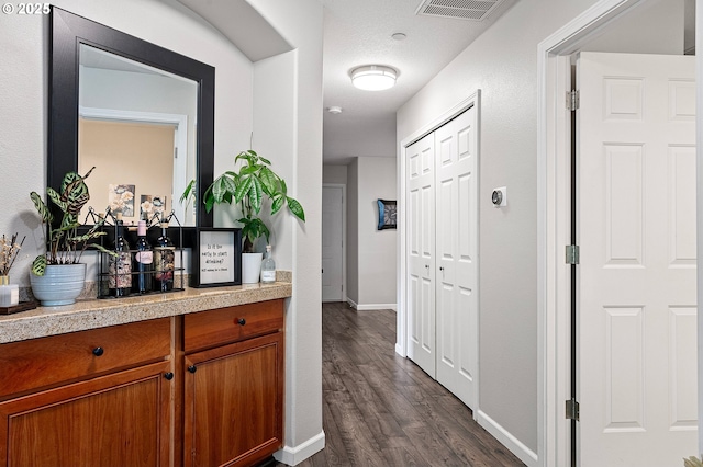 30366 SW Ruth St Unit 70, Wilsonville, OR 97070 - hallway featuring dark wood-type flooring, baseboards, and visible vents