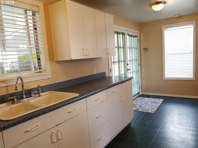 335 Kourt Dr, Eugene, OR 97404 - kitchen featuring white cabinets, plenty of natural light, and dark countertops