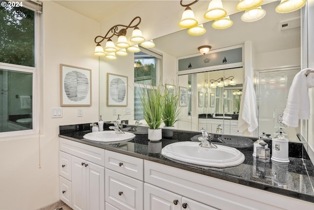 bathroom with walk in shower and vanity