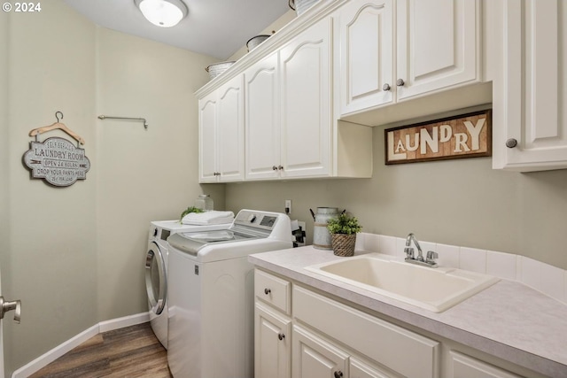 washroom with washer and dryer, sink, cabinets, and dark wood-type flooring