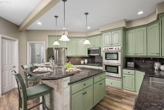 kitchen with tasteful backsplash, a center island, hanging light fixtures, and stainless steel appliances