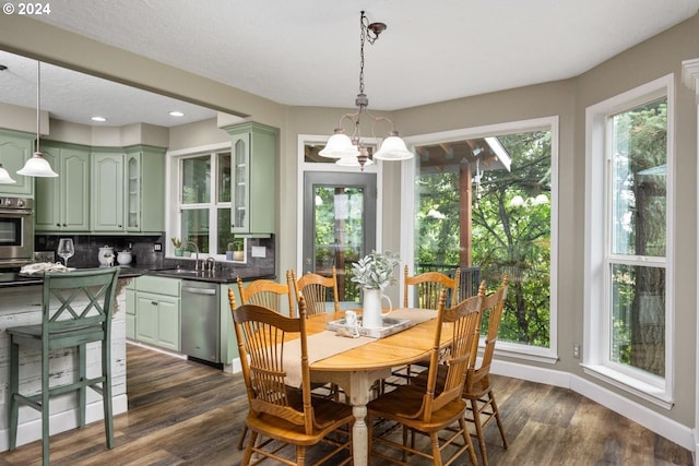 dining space featuring dark hardwood / wood-style flooring and a notable chandelier