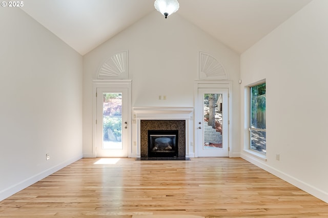 3169 Tanner Park Dr, Eugene, OR 97405 - unfurnished living room with wood finished floors, a fireplace with flush hearth, and high vaulted ceiling