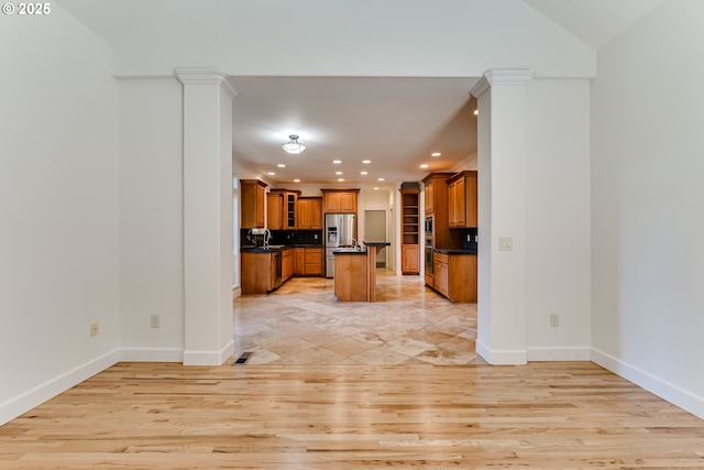 3169 Tanner Park Dr, Eugene, OR 97405 - kitchen featuring appliances with stainless steel finishes, dark countertops, recessed lighting, brown cabinets, and light wood-style floors