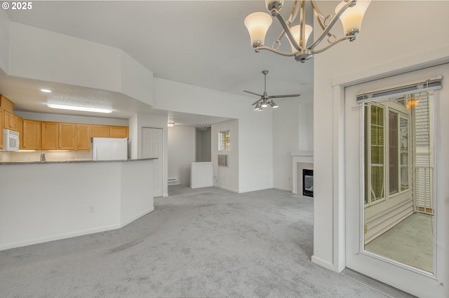 unfurnished living room with light carpet and ceiling fan with notable chandelier