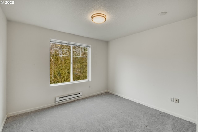 carpeted empty room featuring baseboard heating