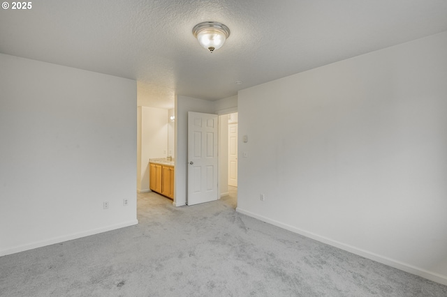 carpeted spare room with a textured ceiling