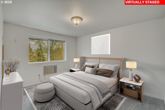 bedroom with a textured ceiling and a wall mounted air conditioner