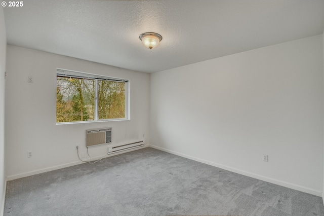 spare room with an AC wall unit, baseboard heating, a textured ceiling, and light carpet