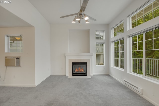 unfurnished living room featuring a baseboard heating unit, light carpet, a fireplace, and ceiling fan