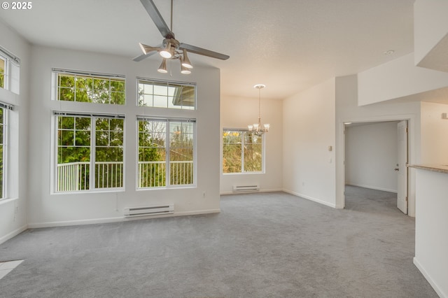 unfurnished living room with light colored carpet, a towering ceiling, ceiling fan with notable chandelier, and a baseboard radiator