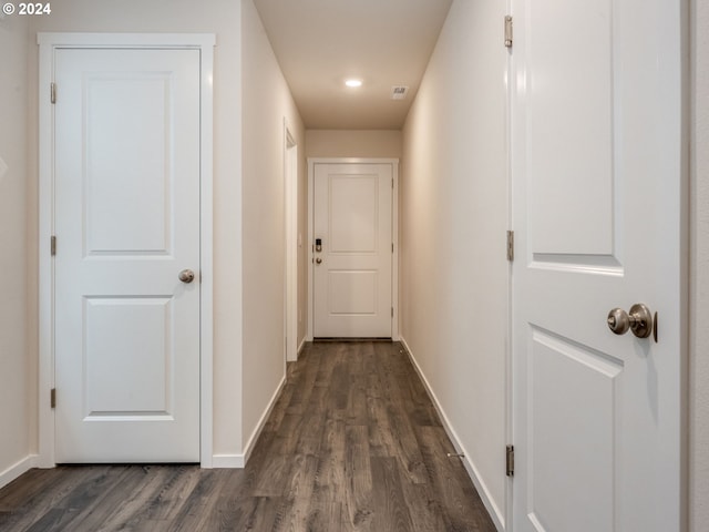 corridor with dark hardwood / wood-style floors