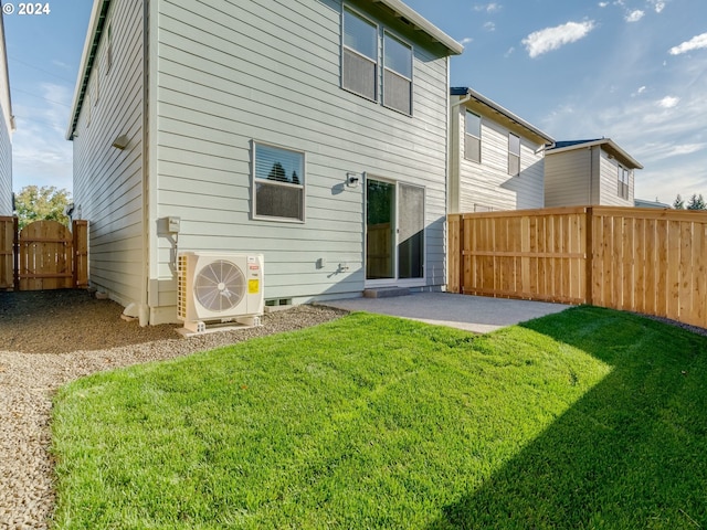 rear view of house featuring ac unit, a patio, and a yard