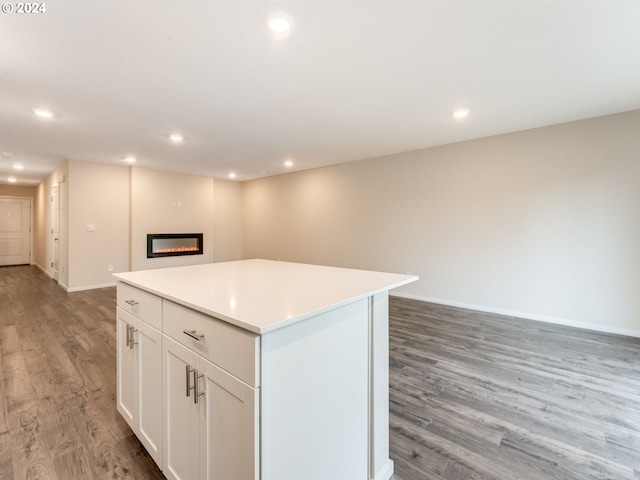 kitchen featuring white cabinetry, a center island, and dark hardwood / wood-style flooring