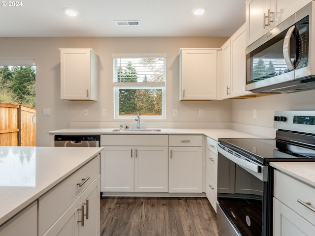 kitchen with white cabinets, appliances with stainless steel finishes, and sink