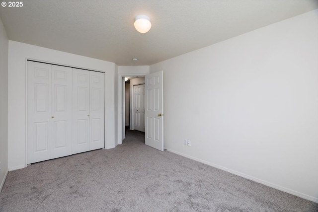 3232 Aspenwood Pl, Forest Grove, OR 97116 - unfurnished bedroom featuring carpet flooring, baseboards, a closet, and a textured ceiling