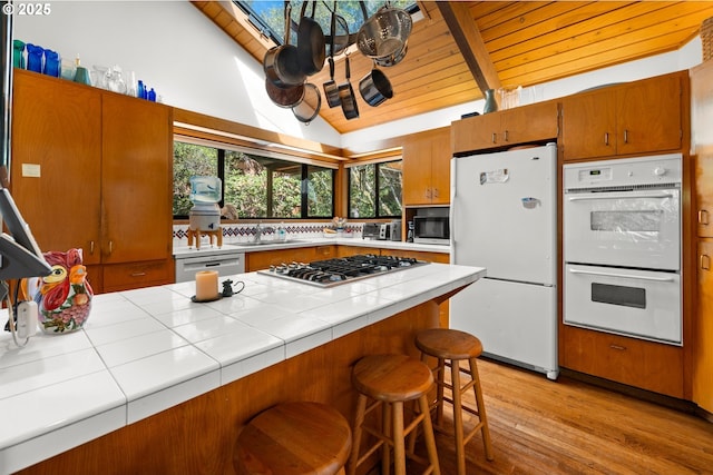3820 SW Scholls Ferry Rd, Portland, OR 97221 - kitchen with a sink, beam ceiling, wooden ceiling, and stainless steel appliances