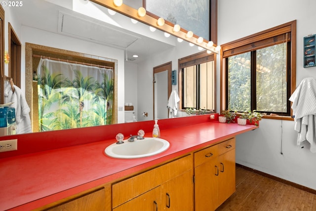 3820 SW Scholls Ferry Rd, Portland, OR 97221 - full bath with vanity, baseboards, a shower with shower curtain, and wood finished floors