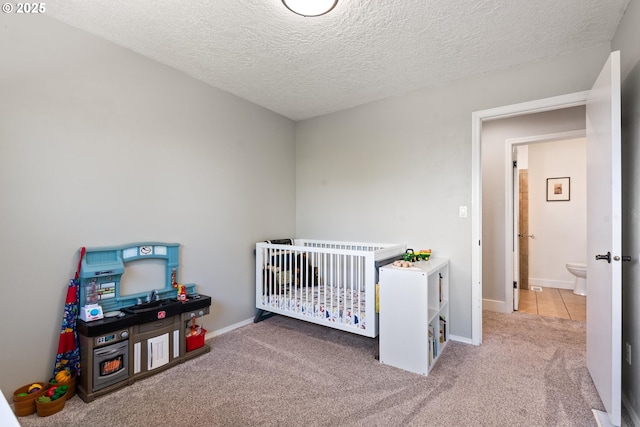 406 Balsa St, La Grande, OR 97850 - carpeted bedroom with a textured ceiling, baseboards, and a crib